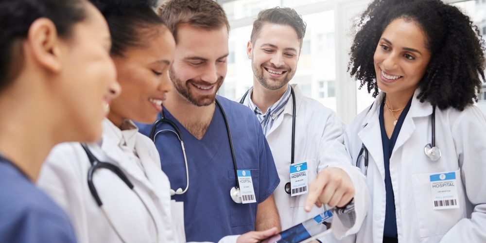 Doctors,,Tablet,And,Meeting,In,Team,Discussion,On,X,Ray,