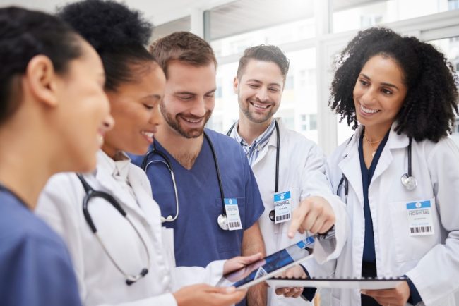 Doctors,,Tablet,And,Meeting,In,Team,Discussion,On,X,Ray,
